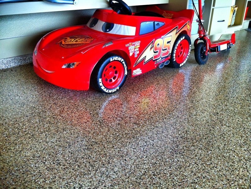 red toy car parked on an epoxy treated floor